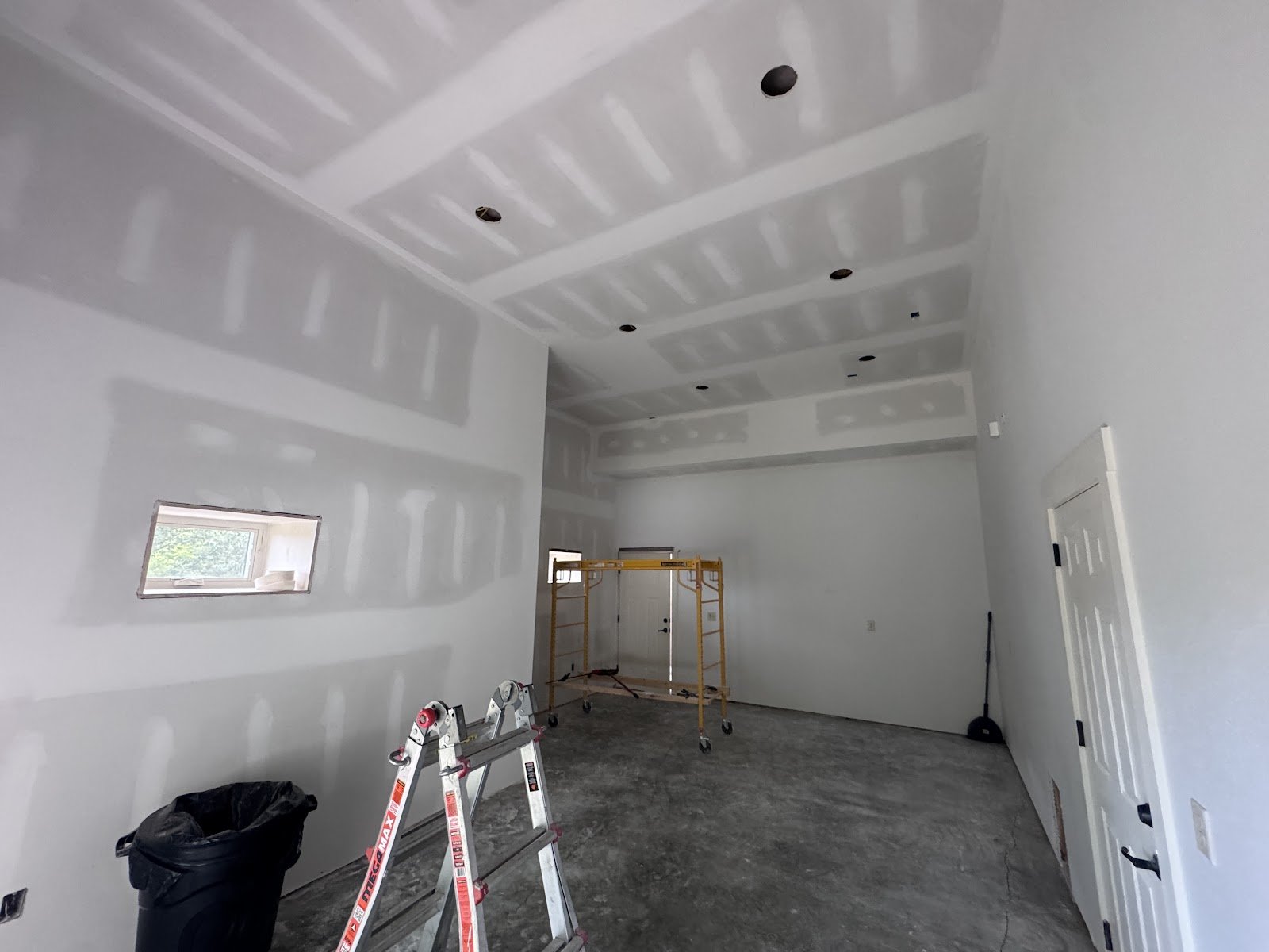 New garage drywall hung and finished along the walls and ceiling